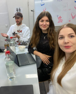 Ein Foto von drei Team-Mitgliedern von Wake up Communications, die während des Krisentrainings mit KI an ihren Laptops arbeiten.